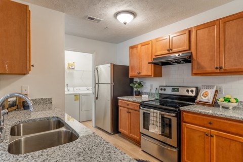 a kitchen with granite counter tops and stainless steel appliances