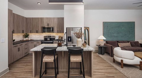 A modern kitchen with a bar stool and a countertop at Liam at Hays Farm in Huntsville, Alabama