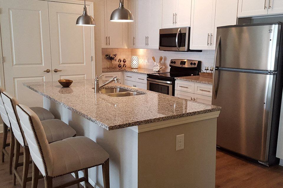 a kitchen with a granite counter top and stainless steel appliances