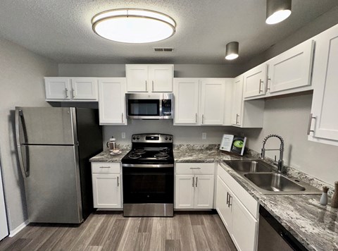 a kitchen with stainless steel appliances and white cabinets