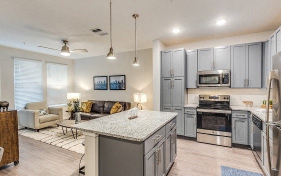 a kitchen and living room with a counter top