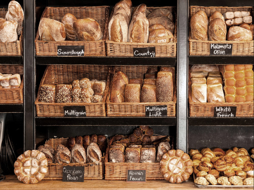 A display of various types of bread in baskets.