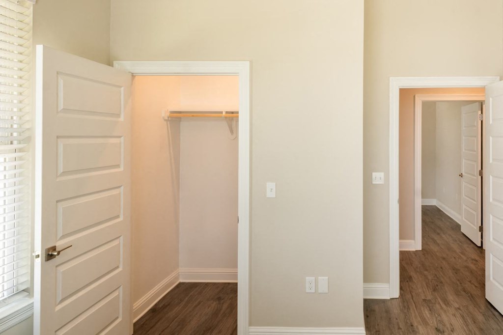 a bedroom with a closet and a door that is open