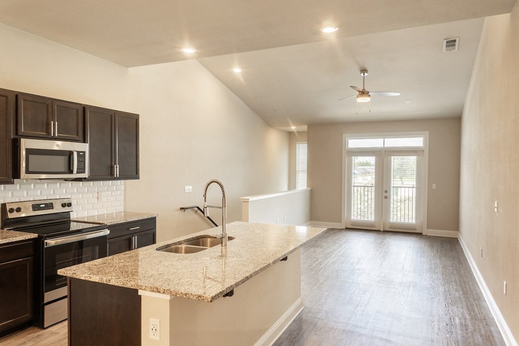 a kitchen and living room with a sink and stove