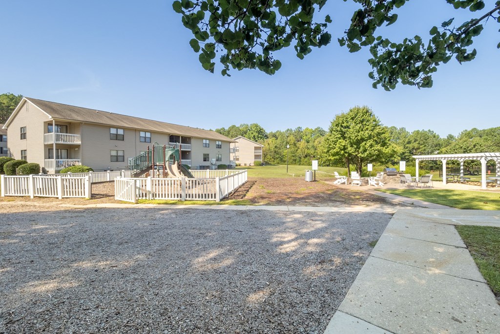 the view of a building with a yard and a driveway
