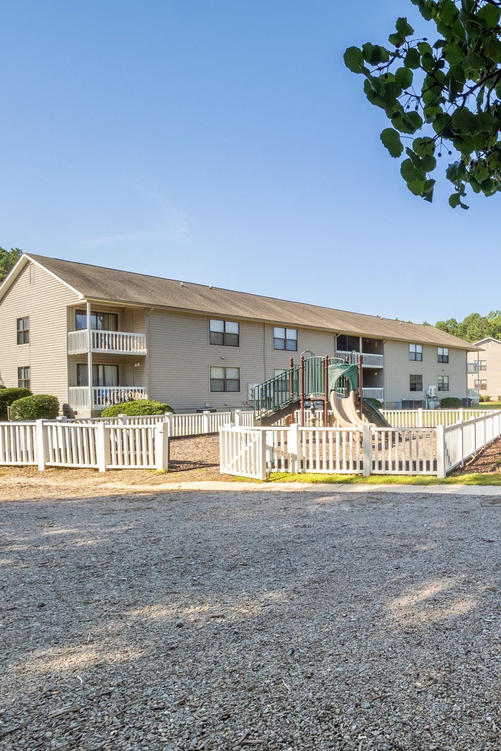 a view of an apartment building with a white fence