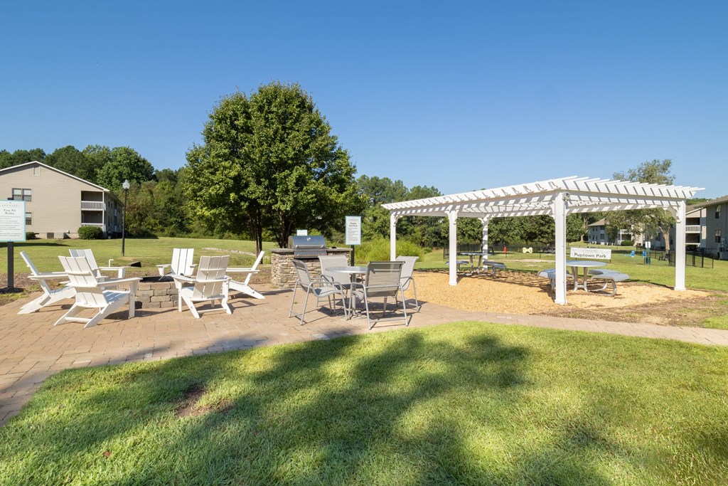 a patio with tables and chairs and a white canopy