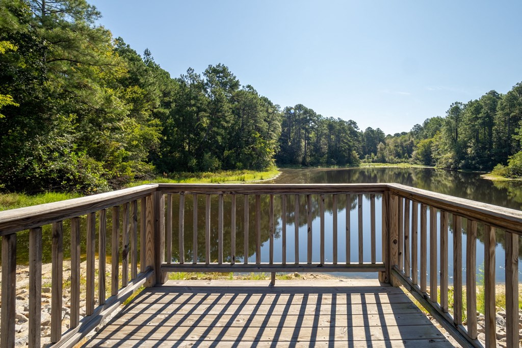 a view of a deck overlooking a lake with trees