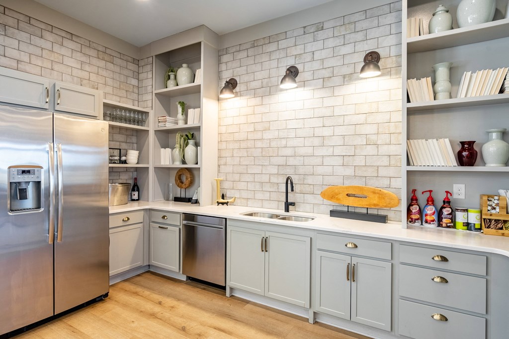 a kitchen with white cabinets and a stainless steel refrigerator