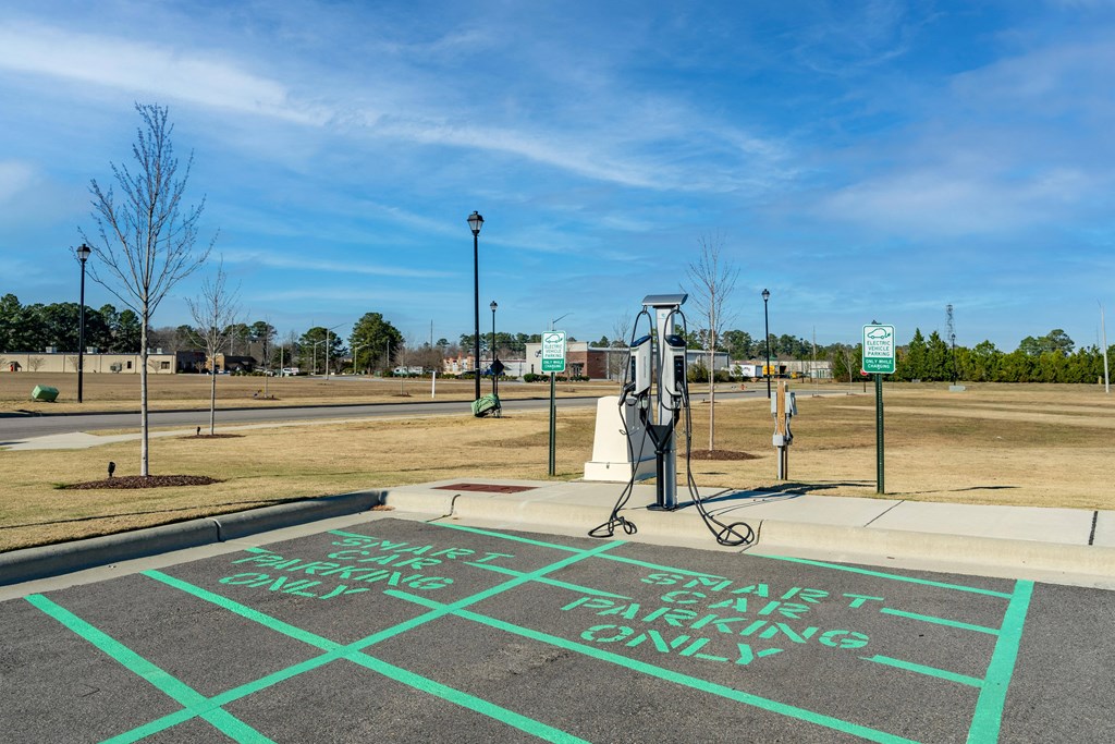 a gas pump in a parking lot at a gas station