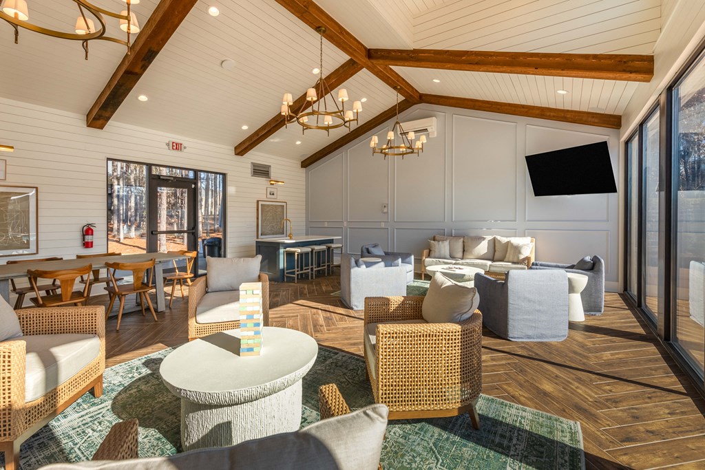 a living room with couches and chairs and a tv