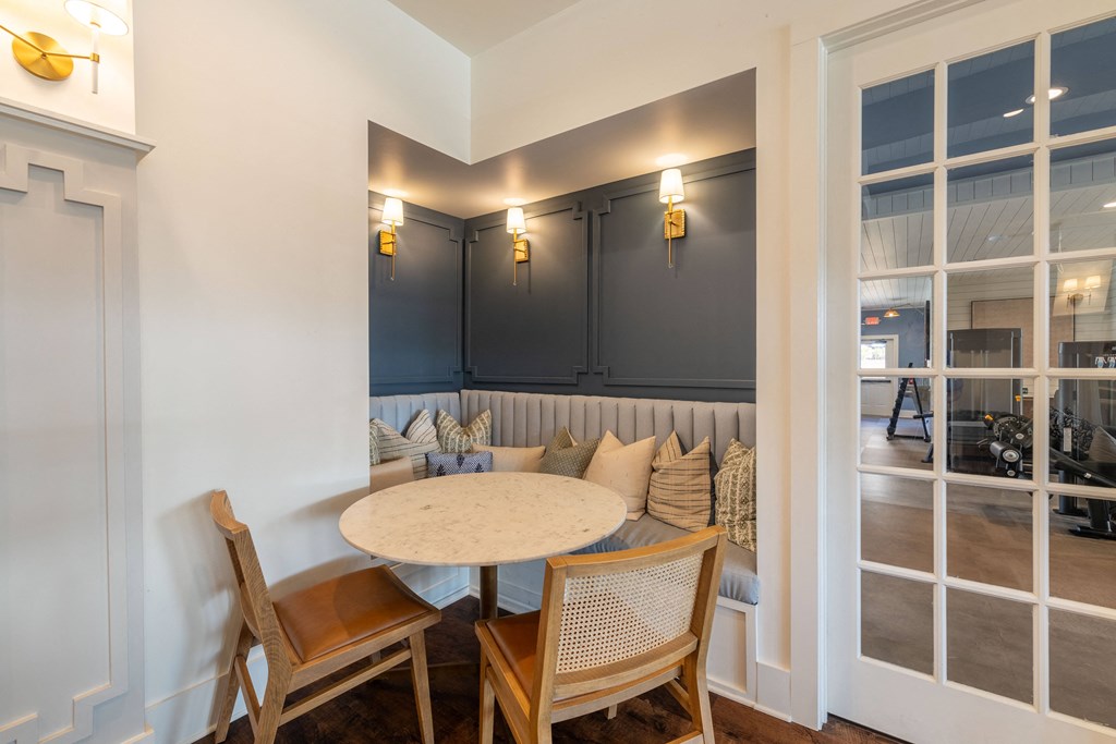 a dining room with a round table and chairs