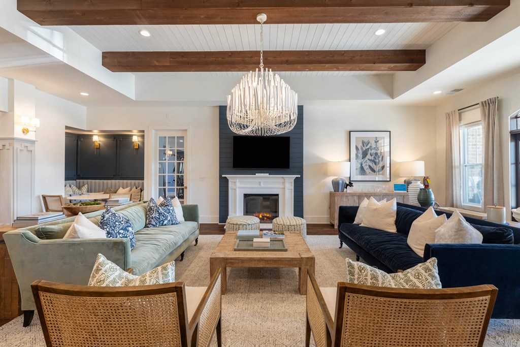 a living room with couches and chairs and a fireplace