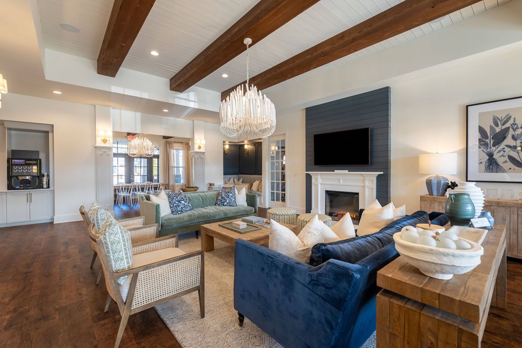a living room with couches and chairs and a fireplace