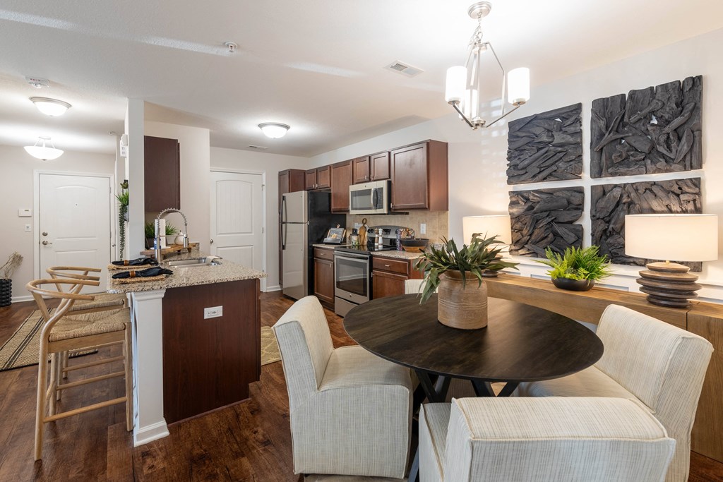 a kitchen and dining room with a table and chairs