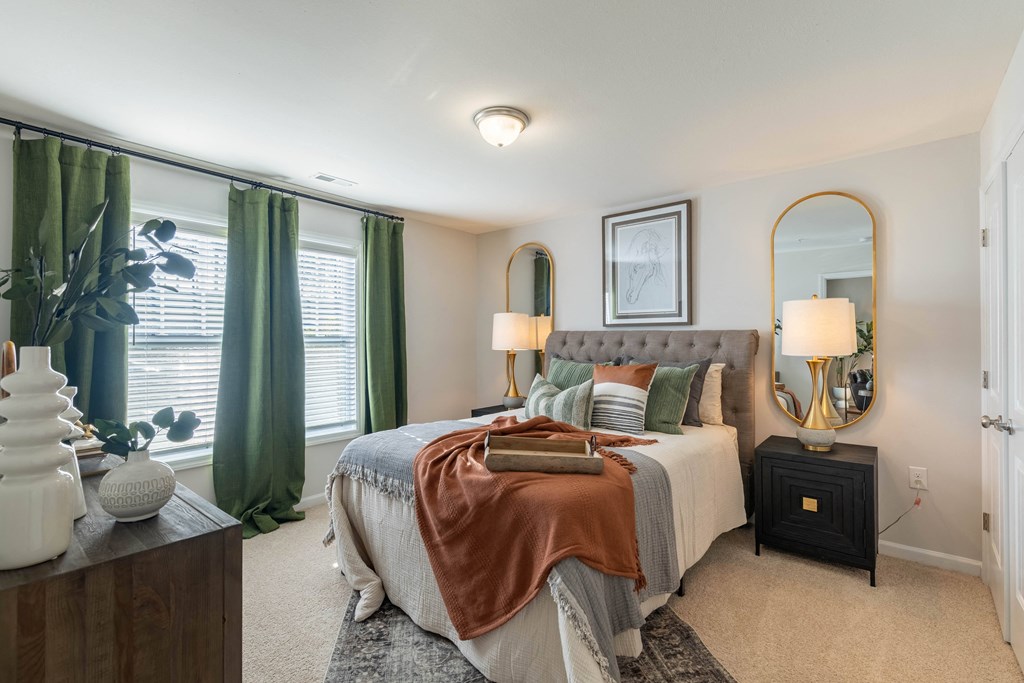 a bedroom with a large bed and green curtains