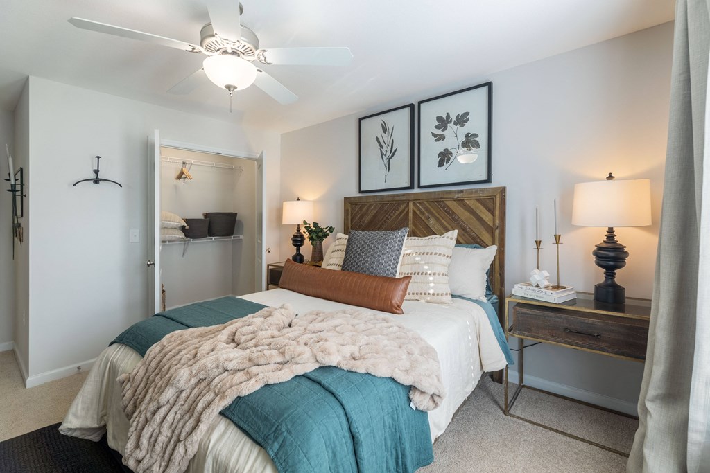 a bedroom with a large bed and a ceiling fan