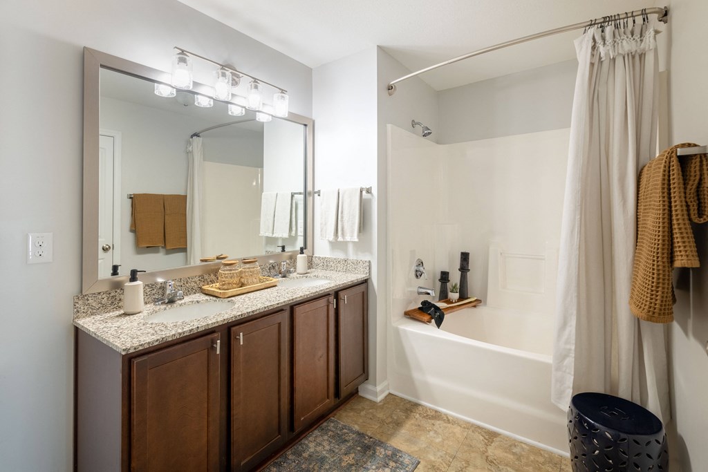 a bathroom with a large mirror and a sink and a tub