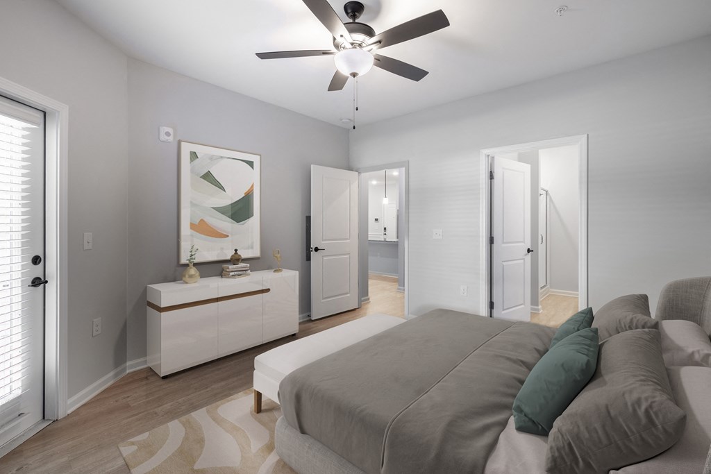 a bedroom with a large bed and a ceiling fan