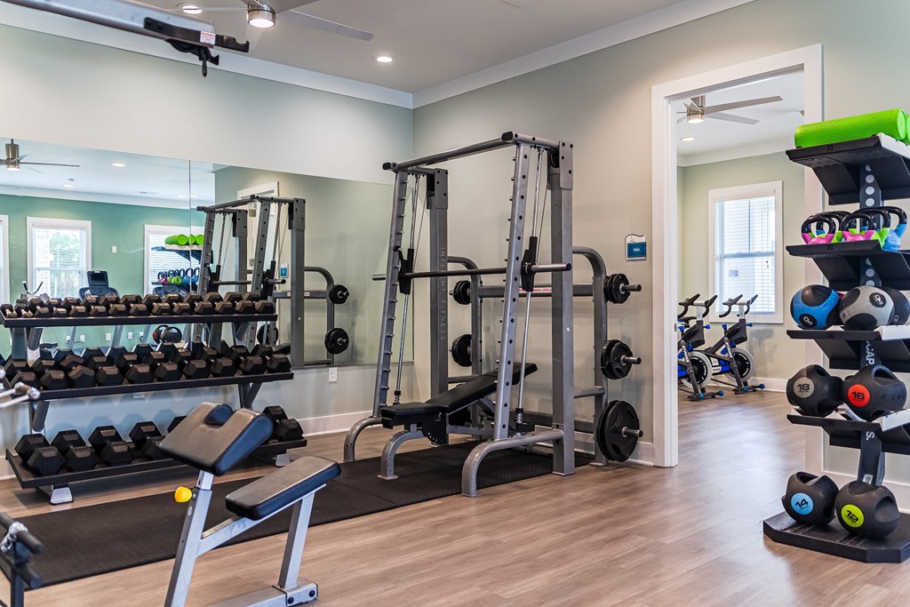 Amenities Highlight Fitness Center with Weight Training Equipment and Pelaton Bikes