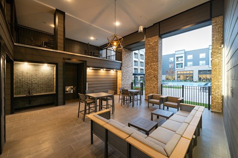 A modern living room with a long wooden table and chairs.