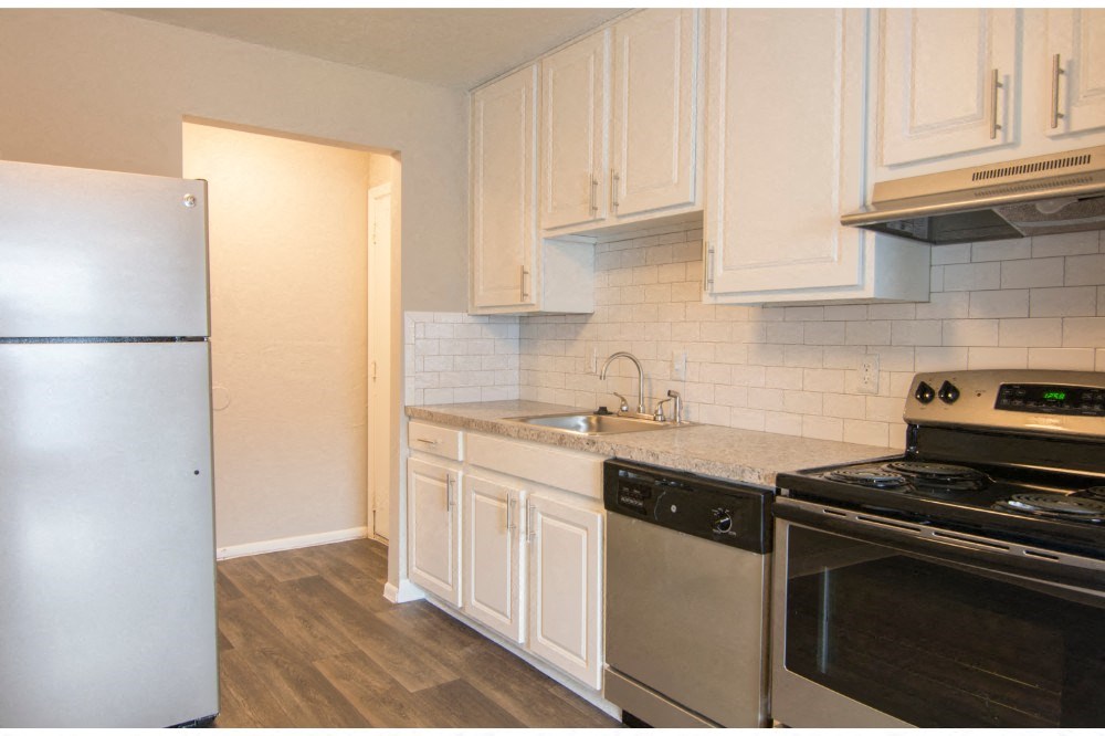a kitchen with stainless steel appliances and white cabinets