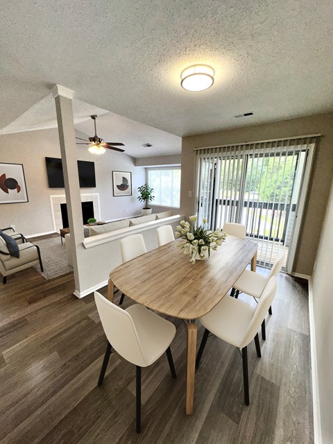 a dining room and living room with a table and chairs