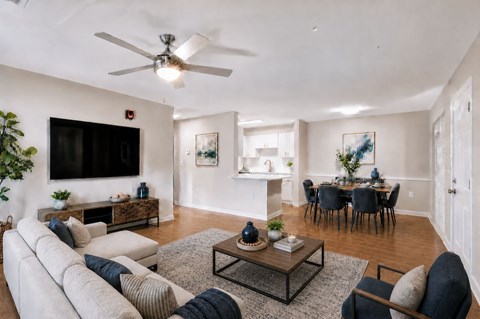 A living room with a white couch and a black coffee table.