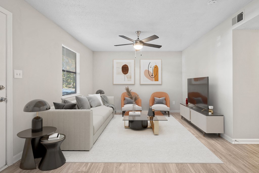 a living room with a couch and a ceiling fan