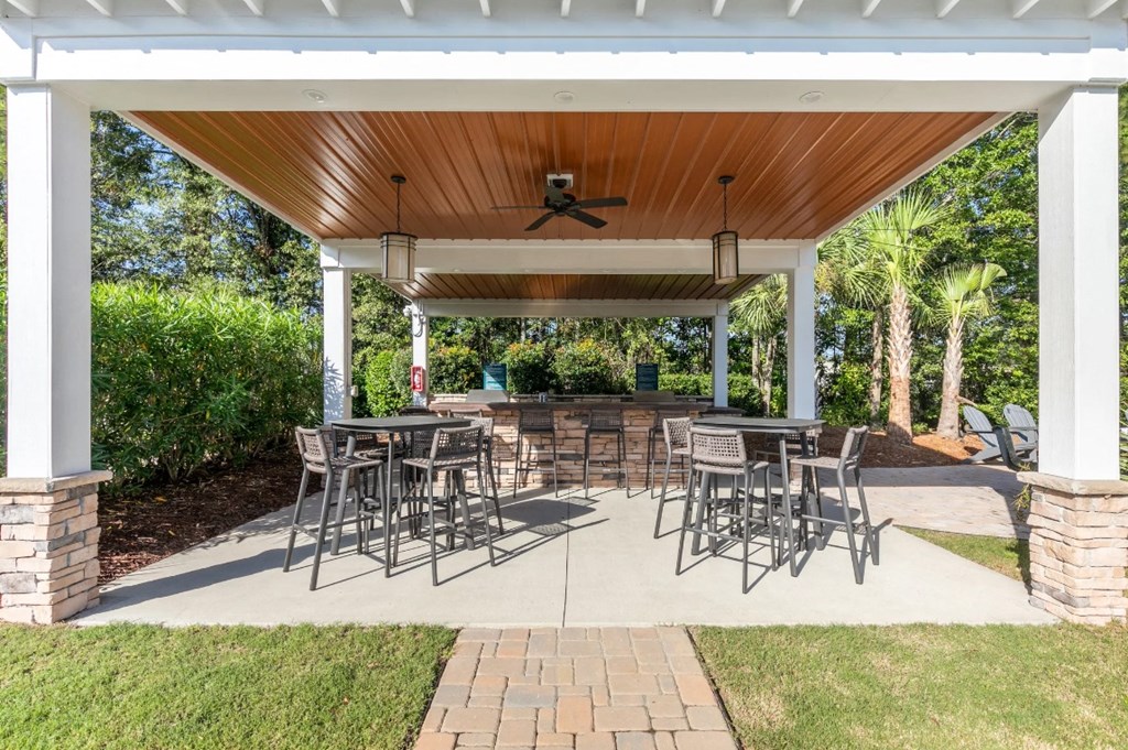 a covered patio with tables and chairs under a pavilion