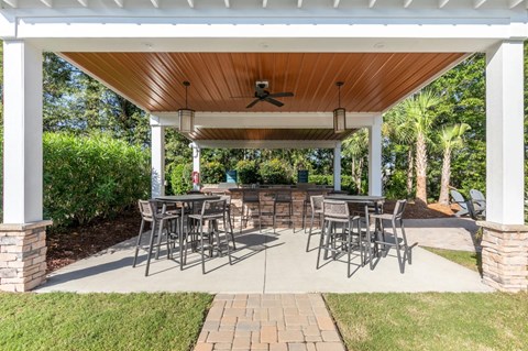 a covered patio with tables and chairs under a pavilion