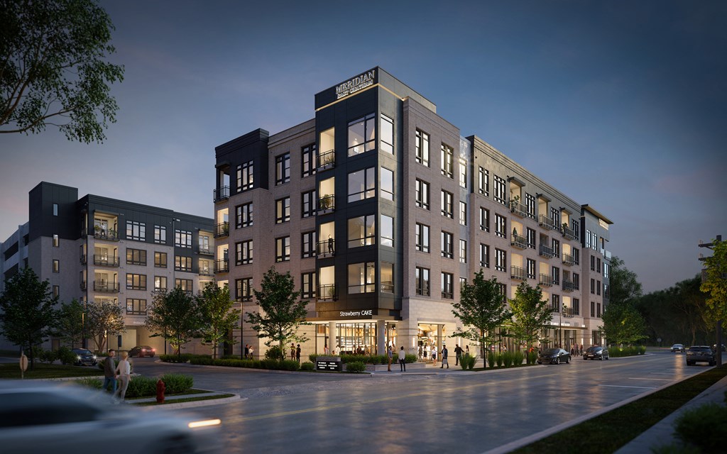 A modern apartment building with a street in front.