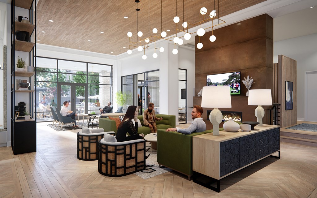 A group of people are sitting in a waiting area with a reception desk.