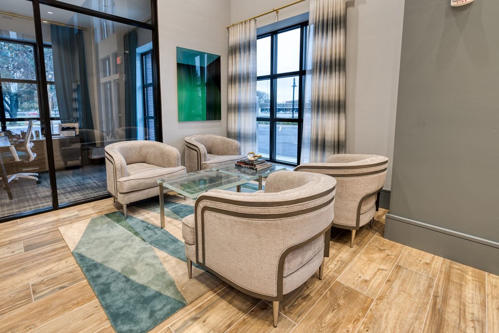 a living room with chairs and a glass table