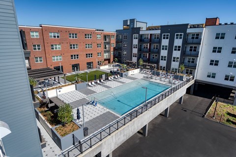 an aerial view of a swimming pool in a building with apartments