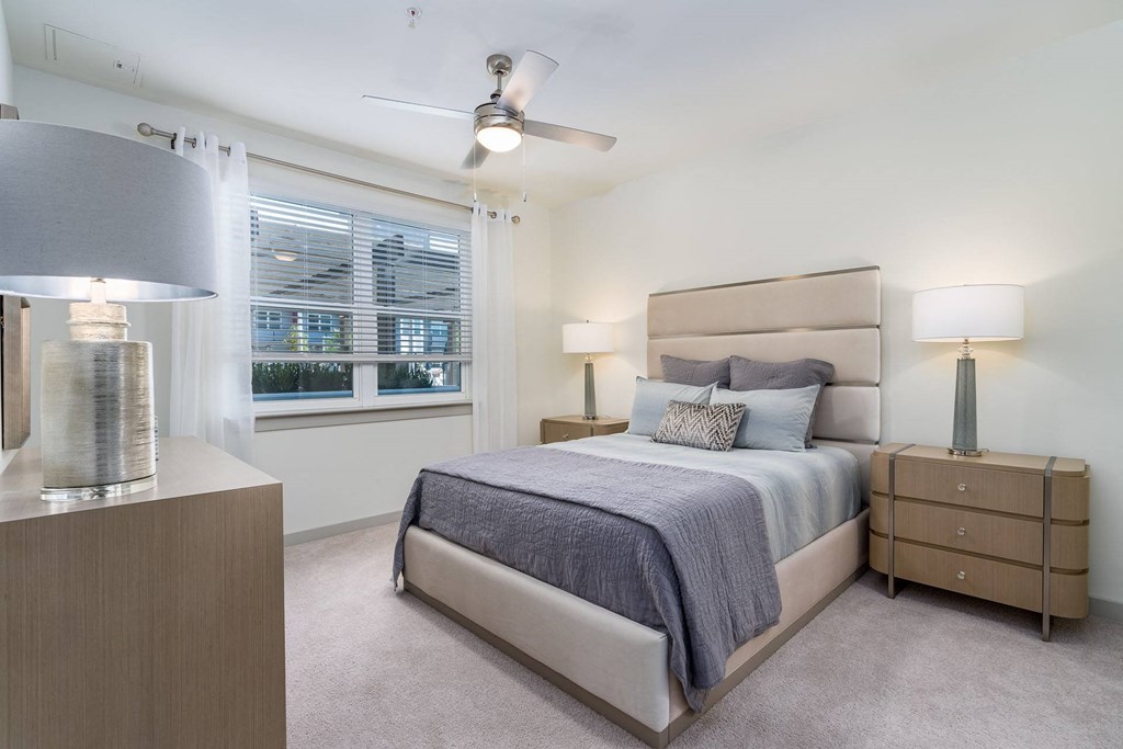 a bedroom with a bed and a ceiling fan