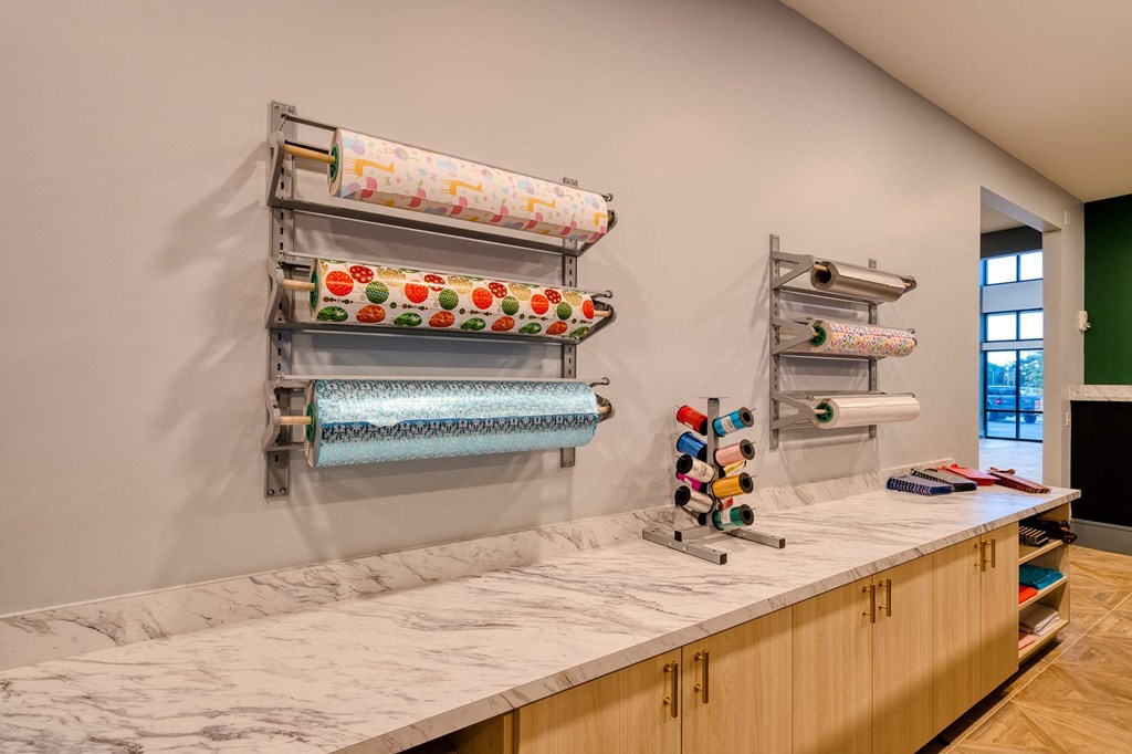 a kitchen with a marble counter top and shelves on the wall