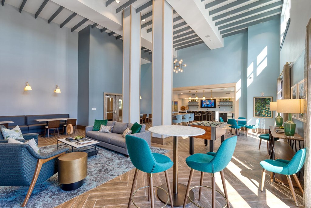a lobby with blue chairs and couches and tables