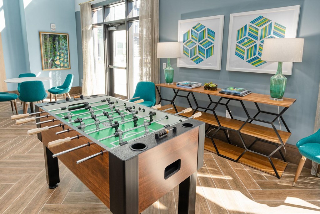 a foosball table in a living room with chairs