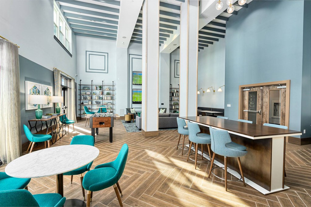 a large room with tables and chairs and a lobby