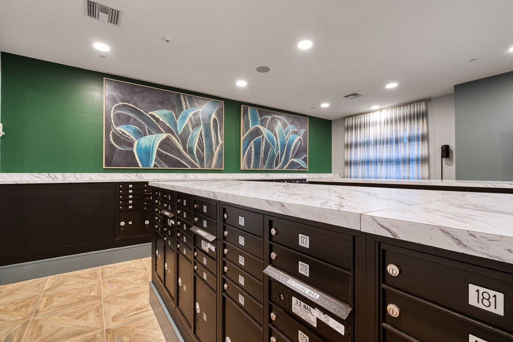 a large counter with many drawers and paintings on the wall