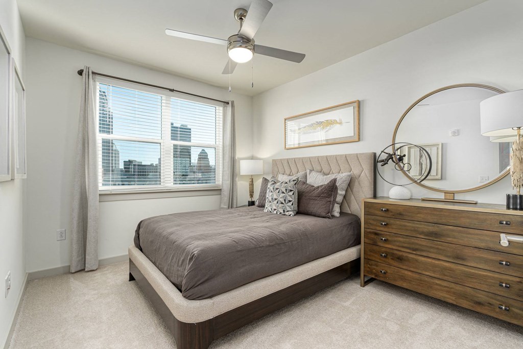 a bedroom with a bed and a ceiling fan