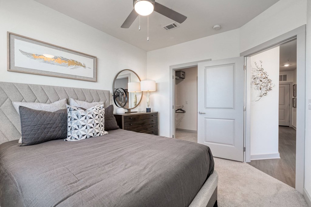 a bedroom with a bed and a ceiling fan