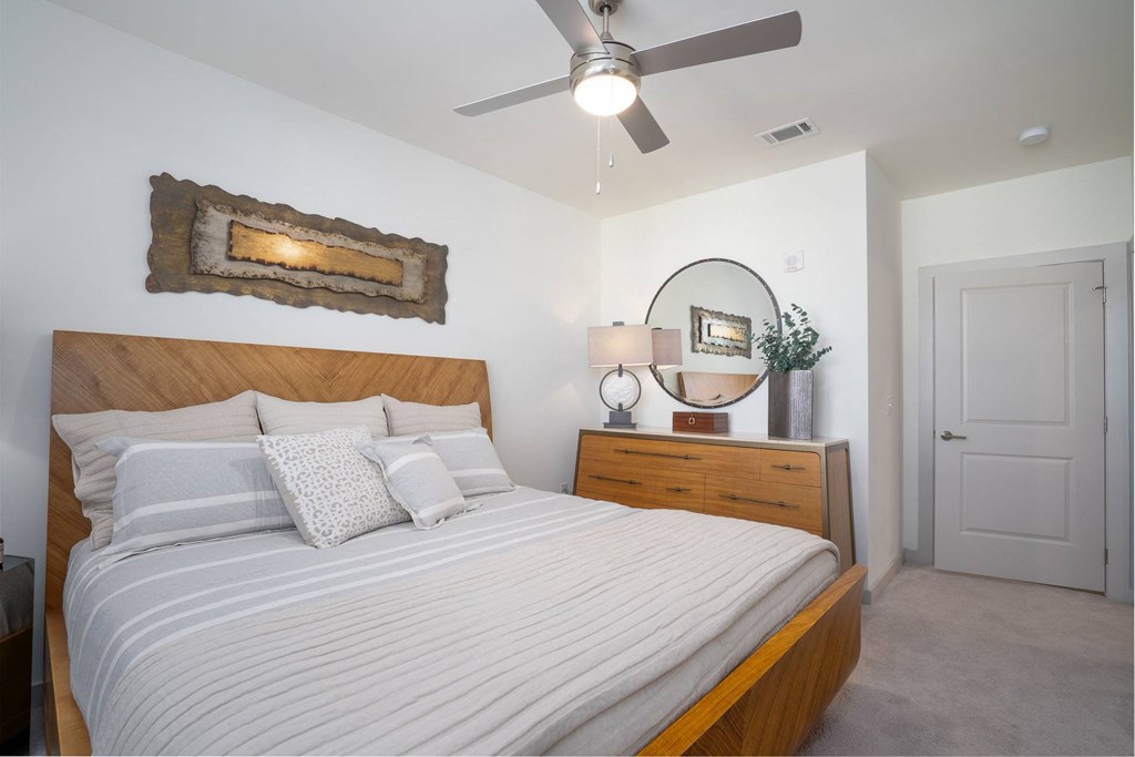 a bedroom with a bed and a ceiling fan