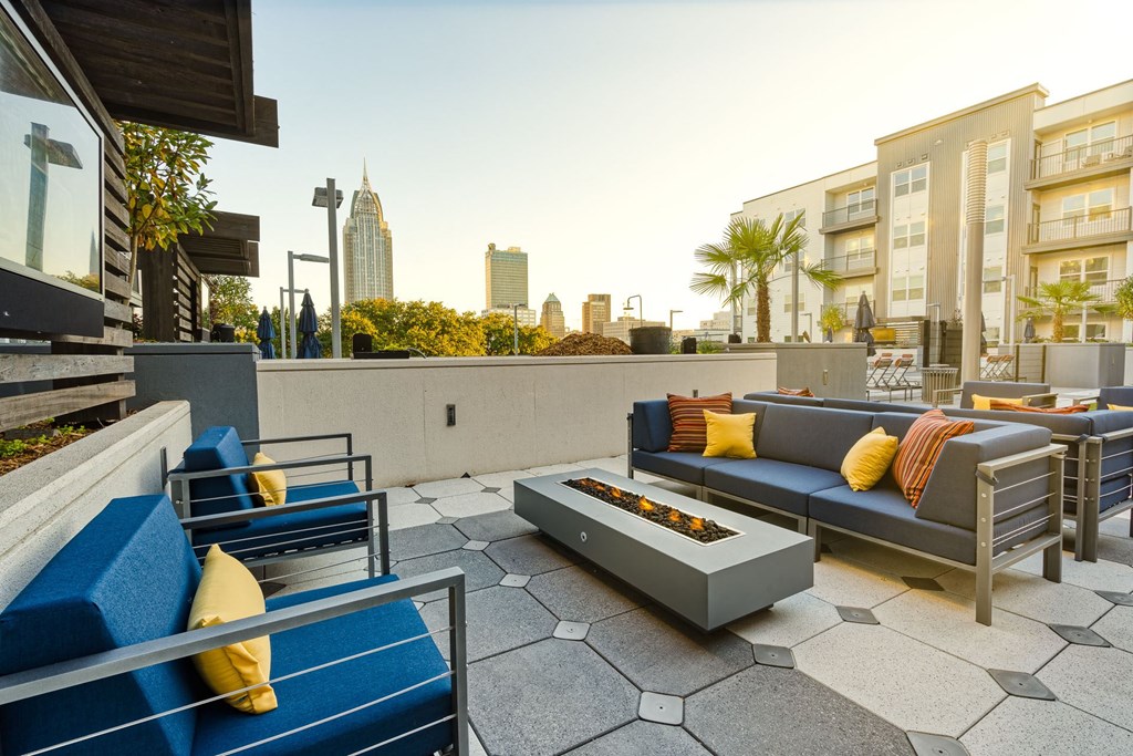 a living room with couches and a coffee table on a patio