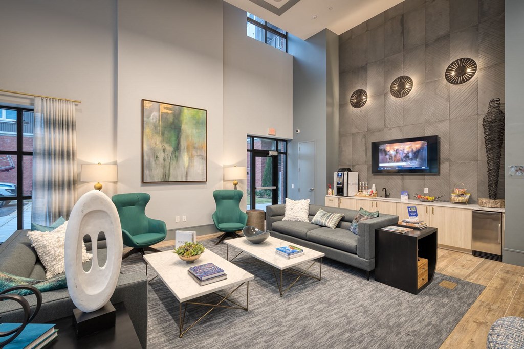 a living room with couches and chairs and a television