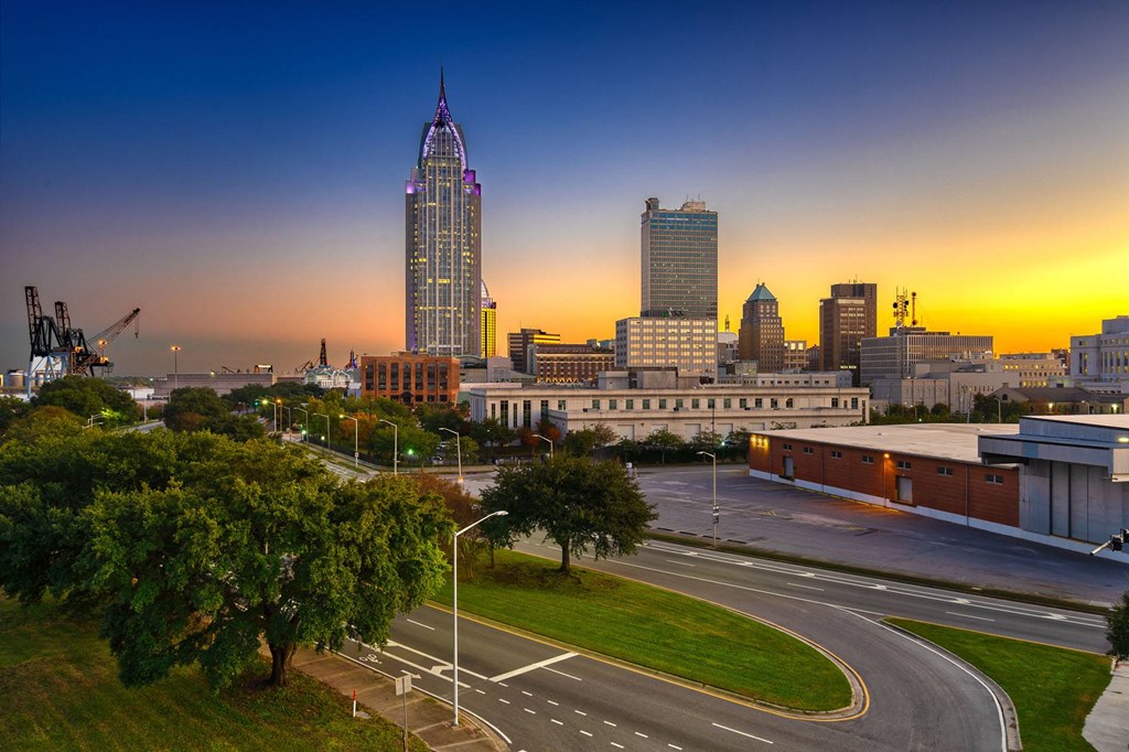 a city at sunset with the skyline in the background