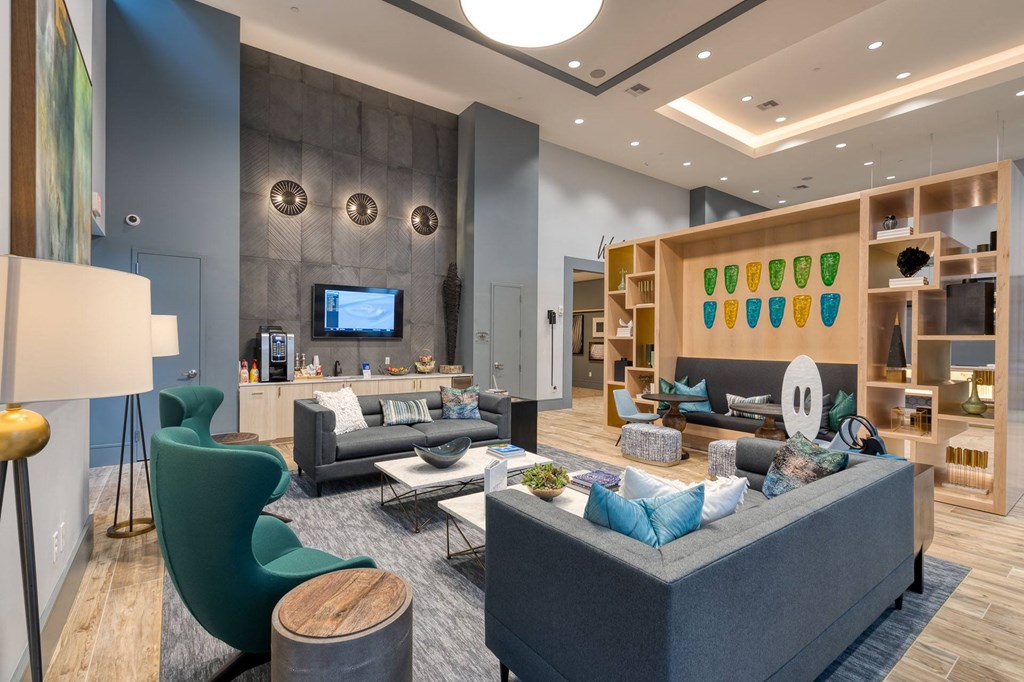 a living room with couches and chairs and a television