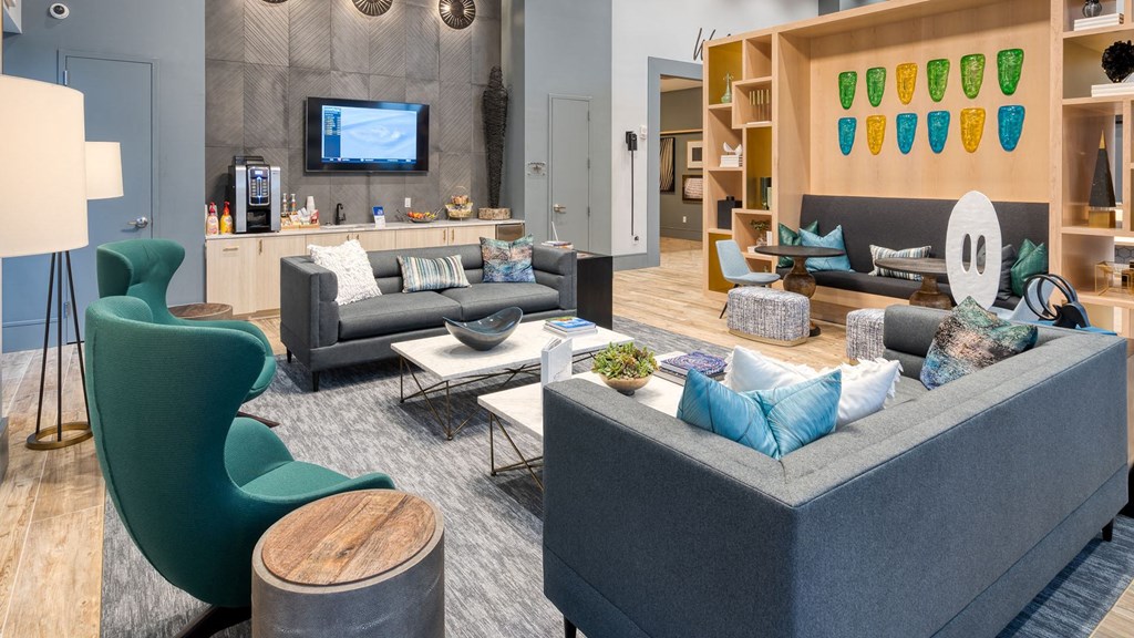 a living room with couches and chairs and a television