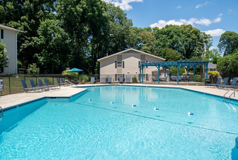 A large swimming pool with a building in the background.